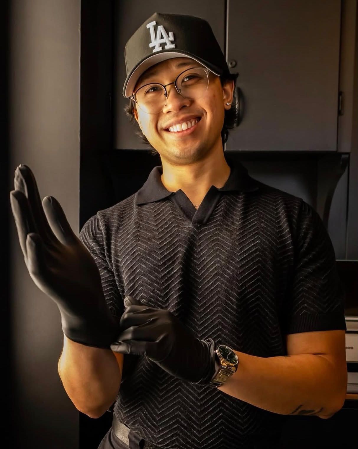 Ian Vincent smiling as he pulls on black gloves.