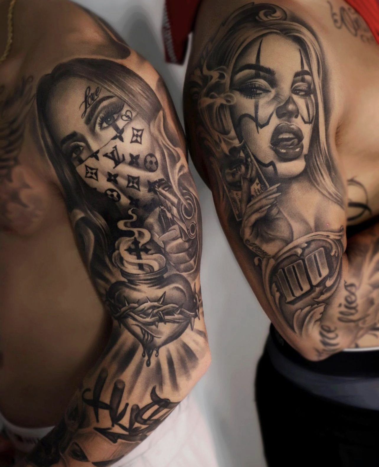 Two black and grey arm sleeves with women's portraits, a sacred heart and lettering.