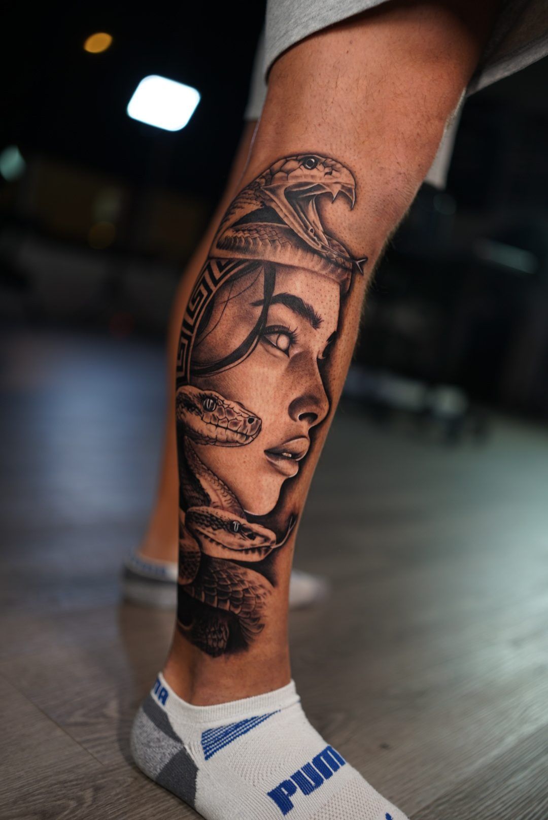 Medusa portrait with snakes on a calf, seen from the side.